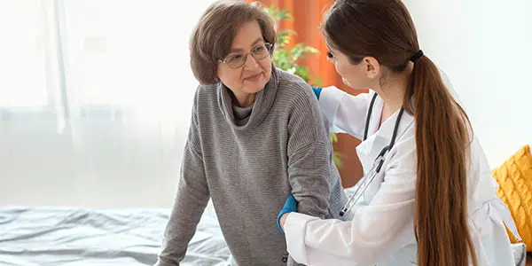 Médica auxilia idosa